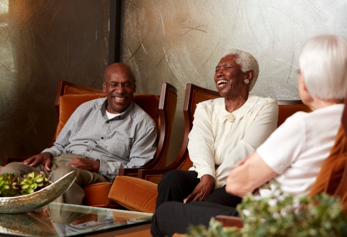 Residents sitting together, talking and smiling