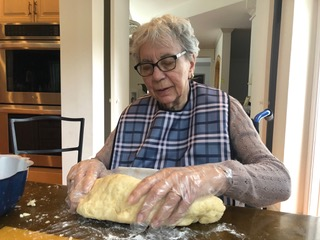 Resident helping make poundcake dough in the kitchen