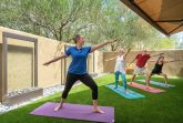 Residents doing yoga outside with a yoga instructor