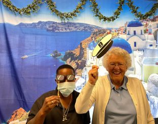 Residents posing in front of a Greece backdrop