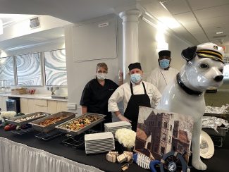 Cambridge's chefs posing behind the "captain's lunch" meal