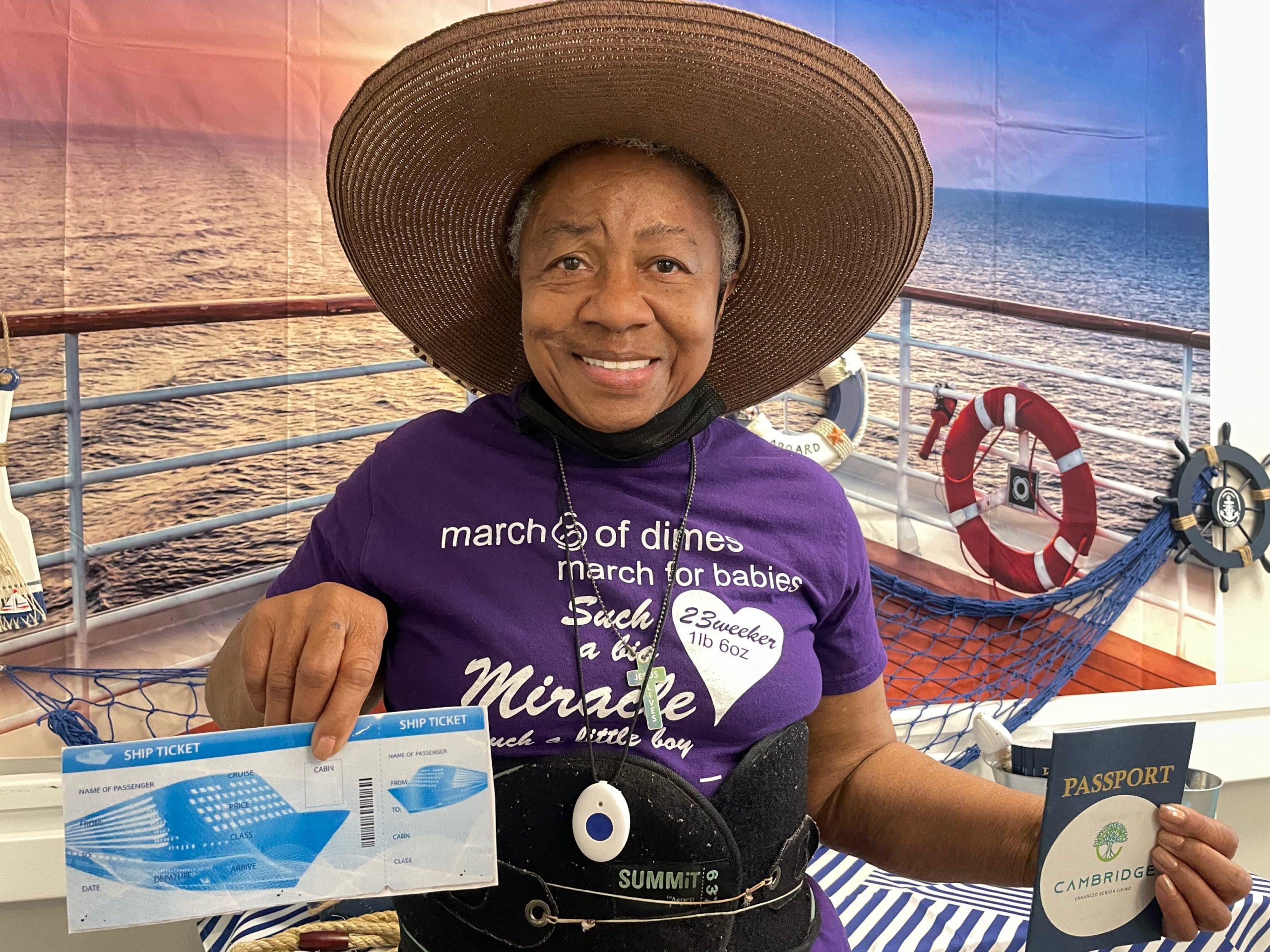 Smiling resident holding a cruise ticket and passport