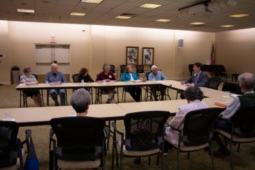 Liebreich and residents sitting around a table, talking