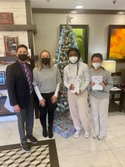 Gary Bauer, Saracen and two high school students posing with some of the December letters