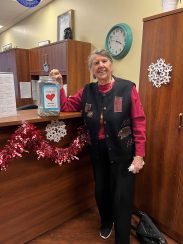 Karp standing next to a pop tab collection jar at The Moorings