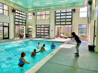 Residents doing water aerobics in a community pool